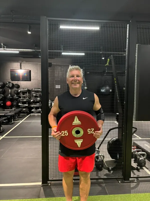 Mark holding the weight he lost